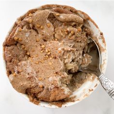 a close up of a bowl of food with a spoon