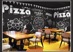 a pizza restaurant with chalkboard walls and chairs around the tables in front of it