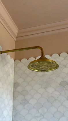 a light fixture on the side of a wall in a room with white circles around it