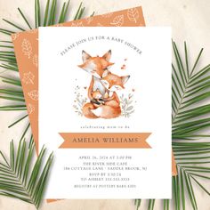 an orange and white baby shower with a fox on it's back, surrounded by leaves