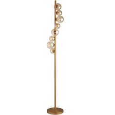 a gold floor lamp with five glass balls on the top and one light bulb at the base