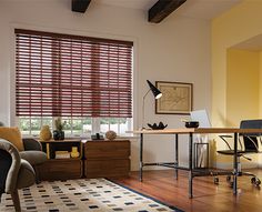 a living room filled with furniture and a window covered in blinds