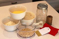 the ingredients to make oatmeal are displayed on the kitchen counter, including bowls and measuring spoons