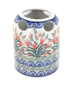 a vase with two holes in the middle and flowers painted on it's sides