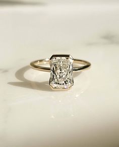 a diamond ring sitting on top of a white counter