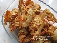 some fried food in a glass bowl on a table