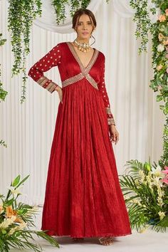 Red crinkle silk floor length padded anarkali embroidered with pearls, stones and sequins. Paired with embellished organza dupatta.