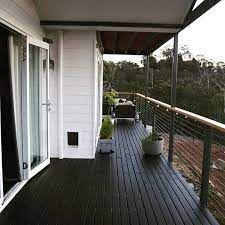 a balcony with wooden floors and white walls