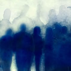 the silhouettes of people are shown in front of a foggy background with blue and white colors