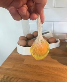 a person is holding an egg shell in their hand while they are preparing to eat it