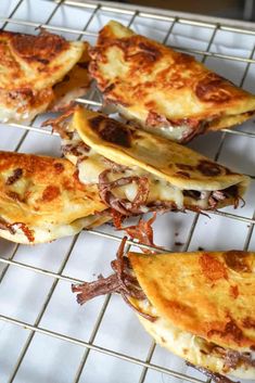 several pieces of pizza sitting on top of a cooling rack