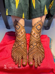 the legs and feet of a woman with henna tattoos