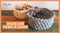 two crocheted baskets sitting next to each other on top of a wooden table