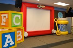 an empty photo frame sitting in the middle of a playroom with blocks and toys