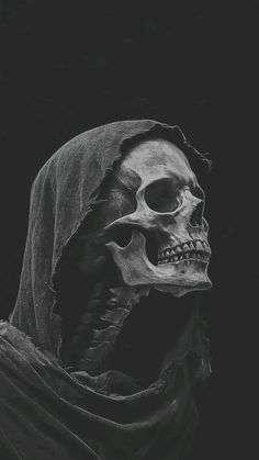 a black and white photo of a skeleton wearing a hood