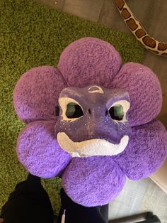 a purple stuffed animal that looks like a flower