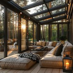 the sun shines through the glass roof in this outdoor living room with couches and pillows