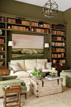 a living room filled with furniture and bookshelves