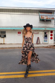 black floral ruffled dress Outfits With Tall Cowgirl Boots, Country Concert Outfit Summer Dress, Cowboy Boots With Maxi Dress, Concert Outfit With Cowboy Boots, Fancy Dress With Cowboy Boots, Lace Skirt Cowboy Boots, Long Dresses And Cowboy Boots, Western Outfits Women Festival, Black Dress Black Cowboy Boots