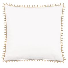 a white pillow with gold trimmings