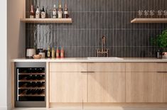 a kitchen filled with lots of bottles of wine and counter top next to a sink