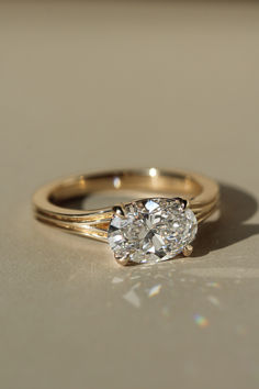 a diamond ring sitting on top of a table