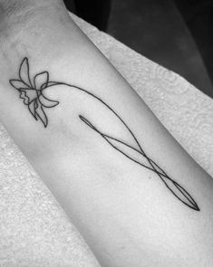 a black and white photo of a person's arm with a flower on it