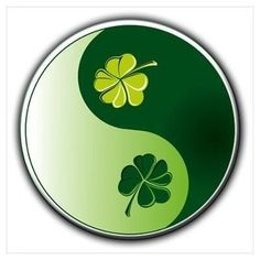 a green and white yin - yang symbol with four leaf clover