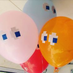 three balloons with different colored squares on them