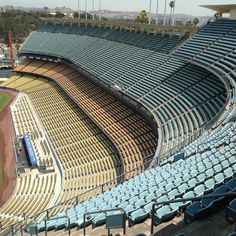 an empty baseball stadium filled with blue seats