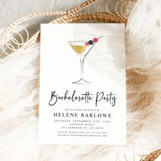 a white card with a martini glass on it and the words bachelor party written in black