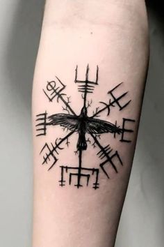 a black and white tattoo on the leg of a person with a cross in it