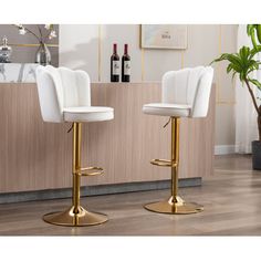 two white bar stools in front of a counter