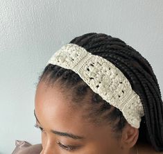 a close up of a woman wearing a headband with crochet on it