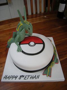 a birthday cake with a pokemon figure on top