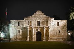 an old stone building lit up at night