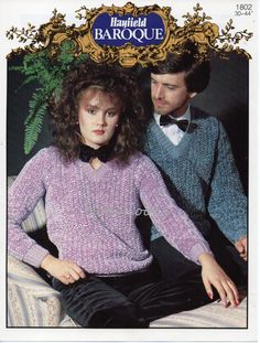 a man and woman sitting next to each other wearing sweaters with bows on their heads