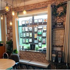 a brick wall with several windows in it and some books on the shelf next to them