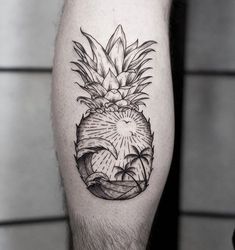 a black and white photo of a pineapple tattoo on the right calf's leg