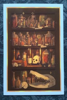 there is a shelf full of bottles and other items on it with a skull in the middle