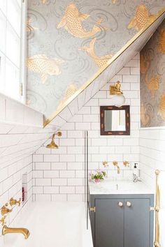 the bathroom is decorated in gold and white