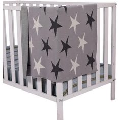 a white crib with black and grey stars on it