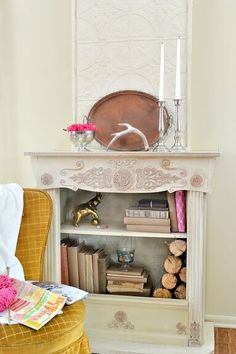 a chair and table in a room with a mirror on the wall above it, next to a yellow chair