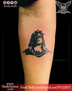 a tattoo on the leg of a person with a lion head and crown in it