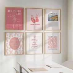 a white table with four framed pictures on the wall