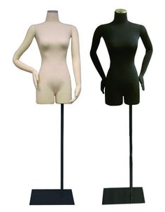 two female mannequins standing next to each other on black stands with white tops