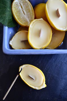 a blue bowl filled with sliced lemons on top of a table