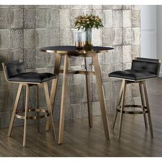 two stools and a table in front of a brick wall with flowers on it