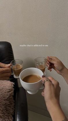 two people sitting at a table with cups of coffee in front of them and the caption says maybe that is indicated to me