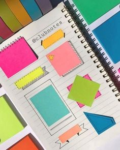 an open notebook with colorful sticky notes on it